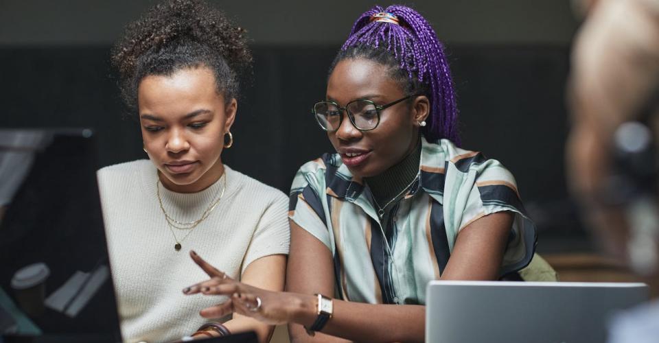 Photo deux jeunes femmes devant un ordinateur